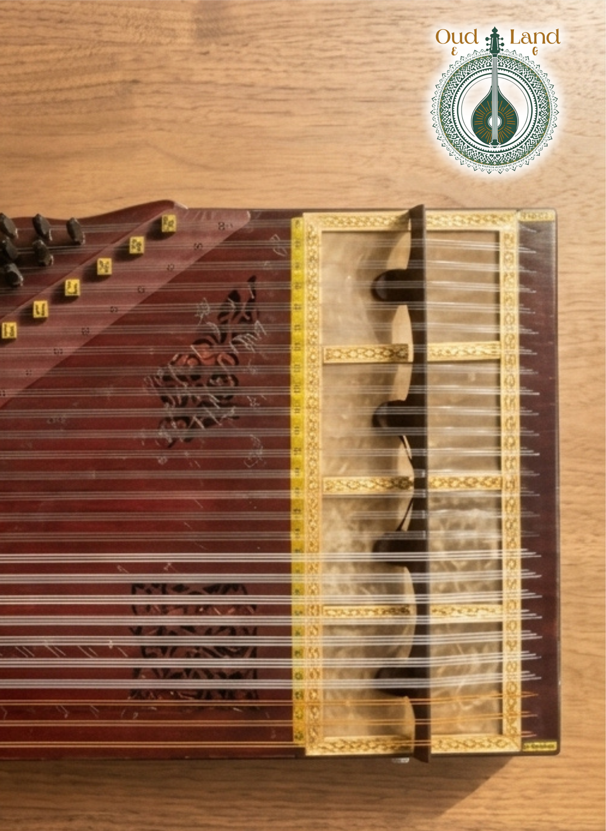 Close-up of a handcrafted Qanun bridge resting on natural fish skin soundboard with clear strings.